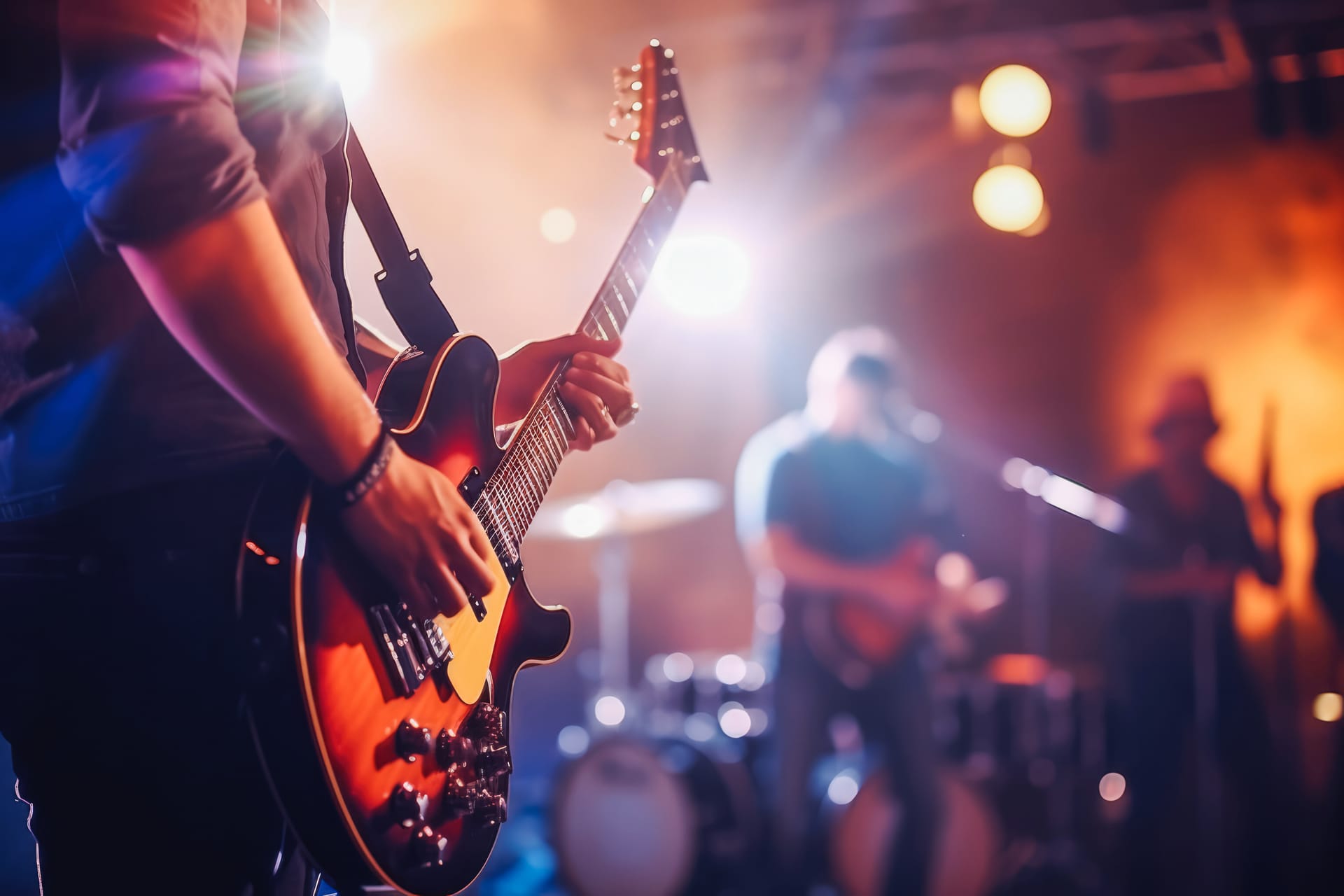 Live band guitarist performing on stage with professional lighting and sound production
