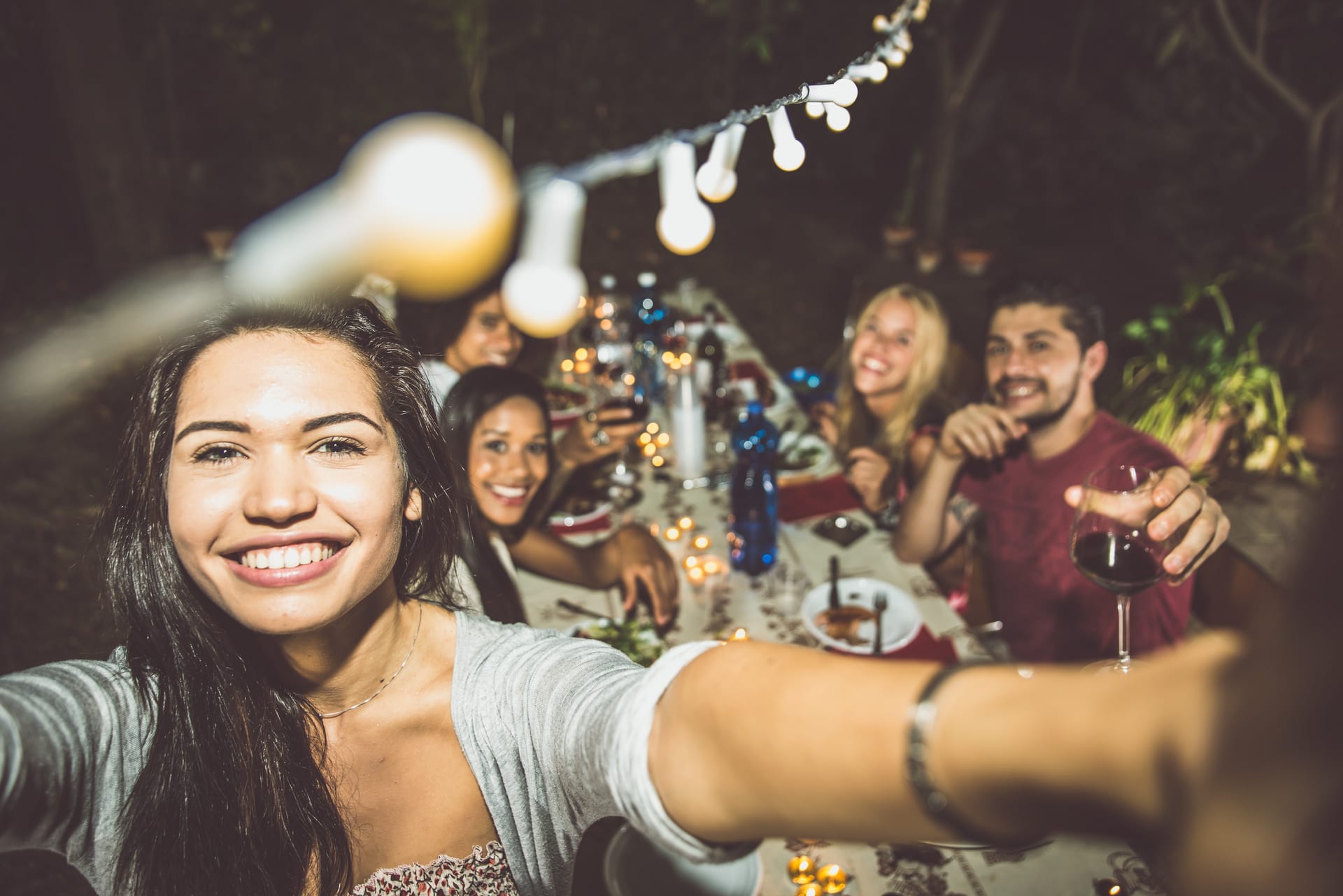 Friends celebrating at a private party with festoon lights